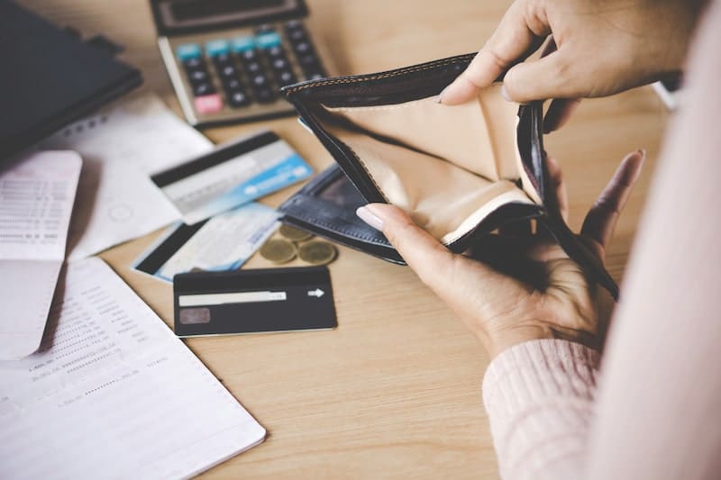 poor Asian woman hand open empty purse looking for money having problem bankrupt broke after credit card payment poor Asian woman hand open empty purse looking for money having problem bankrupt broke after credit card payment