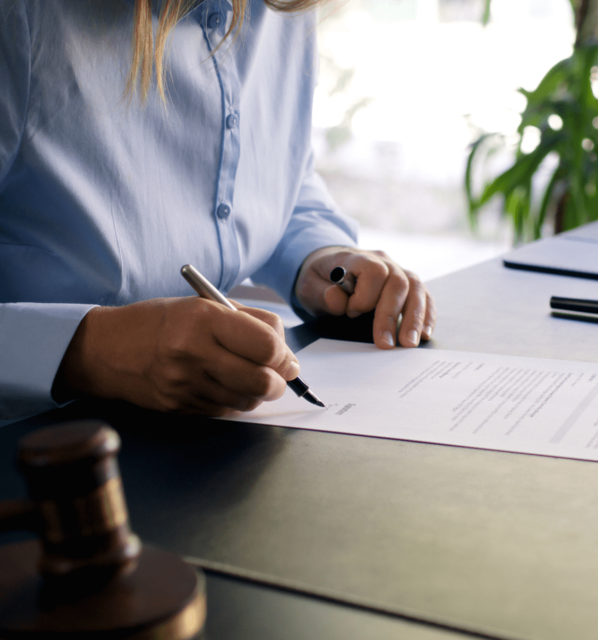 Woman writing on official paperwork