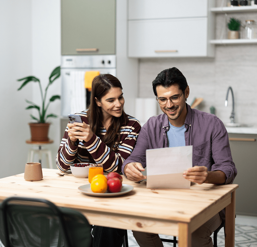 Couple reading document at kitchen table